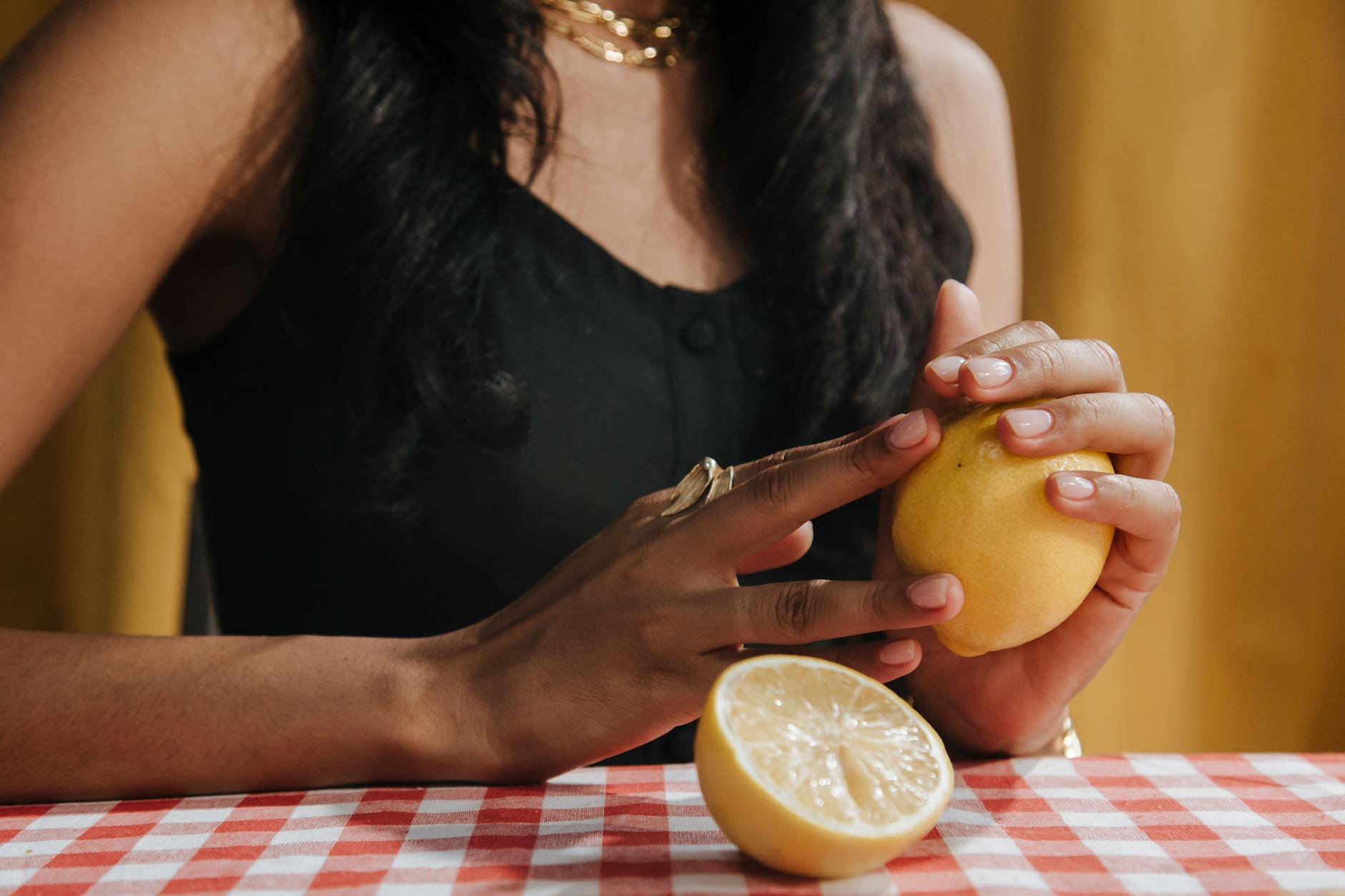 Woman holding a silicone vibrator in a thoughtful pose exploring clitoral stimulation