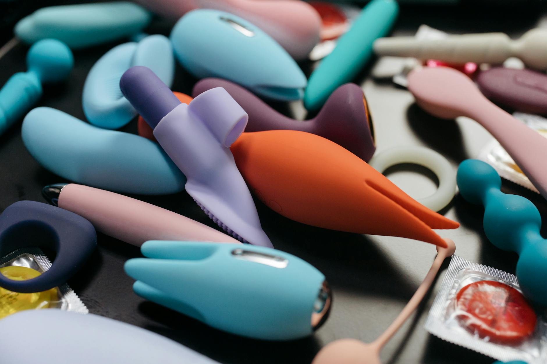 Array of vibrant clitoral vibrators and intimate wellness toys in close-up detail