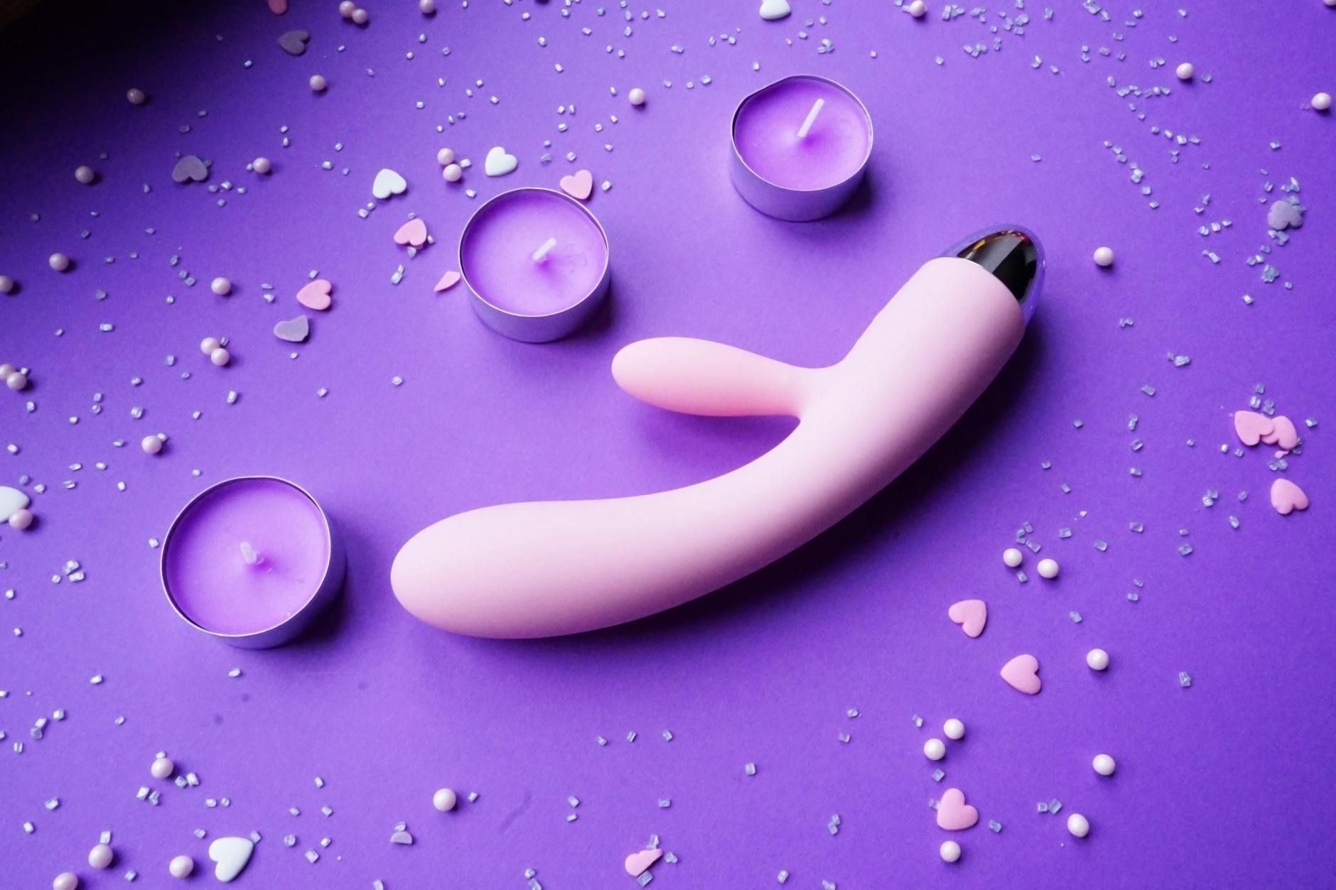 Couple holding a vibrator together, symbolizing intimate exploration and modern pleasure tools.